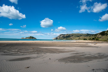  Stunning deserted golden sands on Anauru Bay beach and headland in Gisborne New Zealand on a summers day