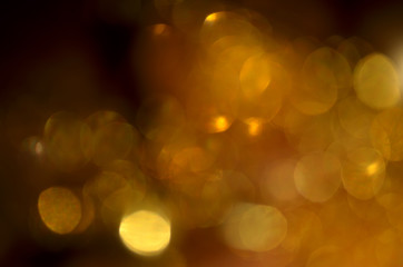 Shiny abstract background with festive defocused lights, golden bokeh. Christmas or New Year holiday concept.