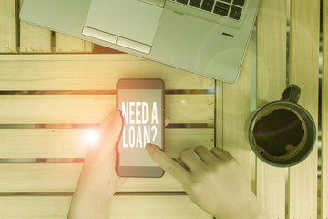 Text sign showing Need A Loan Question. Business photo showcasing asking he need money expected paid back with interest woman computer smartphone drink mug office supplies technological devices