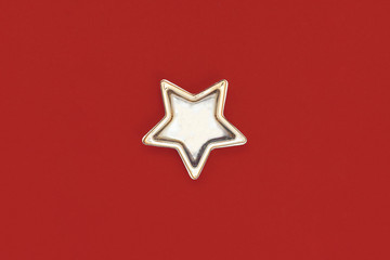 Christmas five pointed golden star on red background. Christmas decoration.