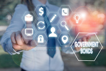 Writing note showing Government Bonds. Business concept for debt security issued by a government to support spending