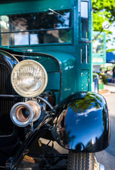 Old vintage retro truck with wooden cabin and open engine at a provincial town street exhibition