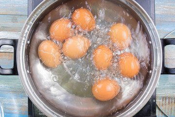 Chef cooking boiled eggs  in pot