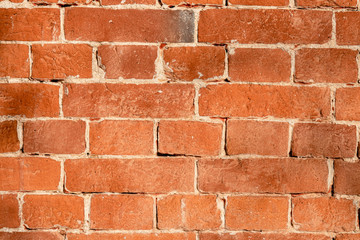 The texture of the old red brick wall with white veins.