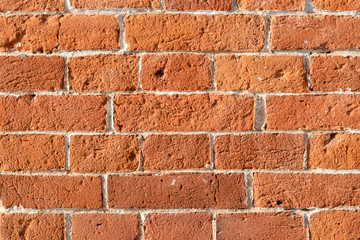 The texture of the old red brick wall with white veins.