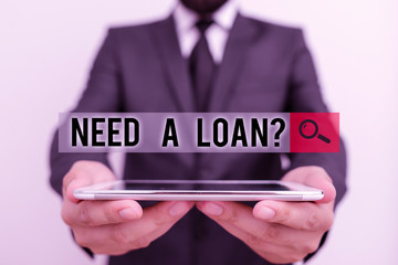 Text sign showing Need A Loan question. Business photo text amount of money that is borrowed often from bank Male human wear formal work suit hold smart hi tech smartphone use hands