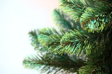 green branches of an artificial Christmas tree. Left place for text. artificial Christmas tree...