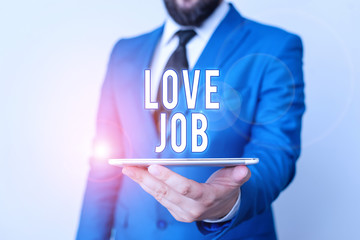 Conceptual hand writing showing Love Job. Concept meaning designed to help locate a fulfilling job that is right for us Businessman in blue suite with a tie holds lap top in hands