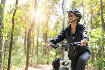 Senior asian woman riding bikes in park
