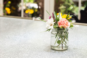 Beautiful flower arrangement in glass vase on the table