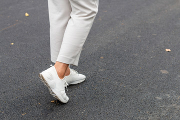 Middle Asian aged woman smiling and jogging in the park.