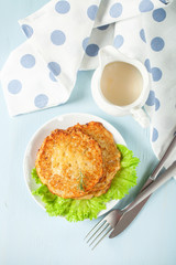 Potato pancakes with salad on a blue background. Rösti . Swiss national dish. Top view