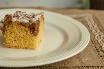 Single piece of coffee crumb cake served on a white plate