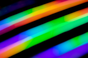 Holographic background with different colors. Holographic lines on black background. Neon line.