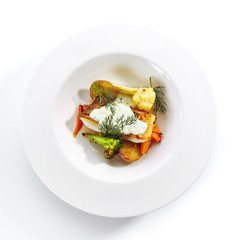 Cod Fillet with Baked Vegetables on White Restaurant Plate Isolated