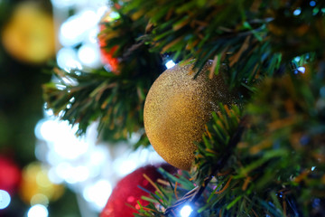 Many colorful shiny mirror balls on an artificial tree in a department store in Christmas and New Year festival and space for write wording, beautiful decoration for promoting to lovers and family