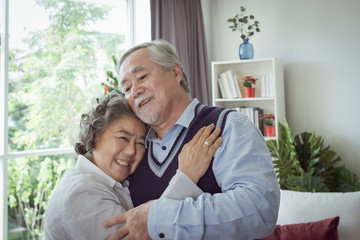 Happy couple old elderly senior man and woman hugging and happy with smiling together at home, retirement and healthcare lifestyle and lover relationship concept