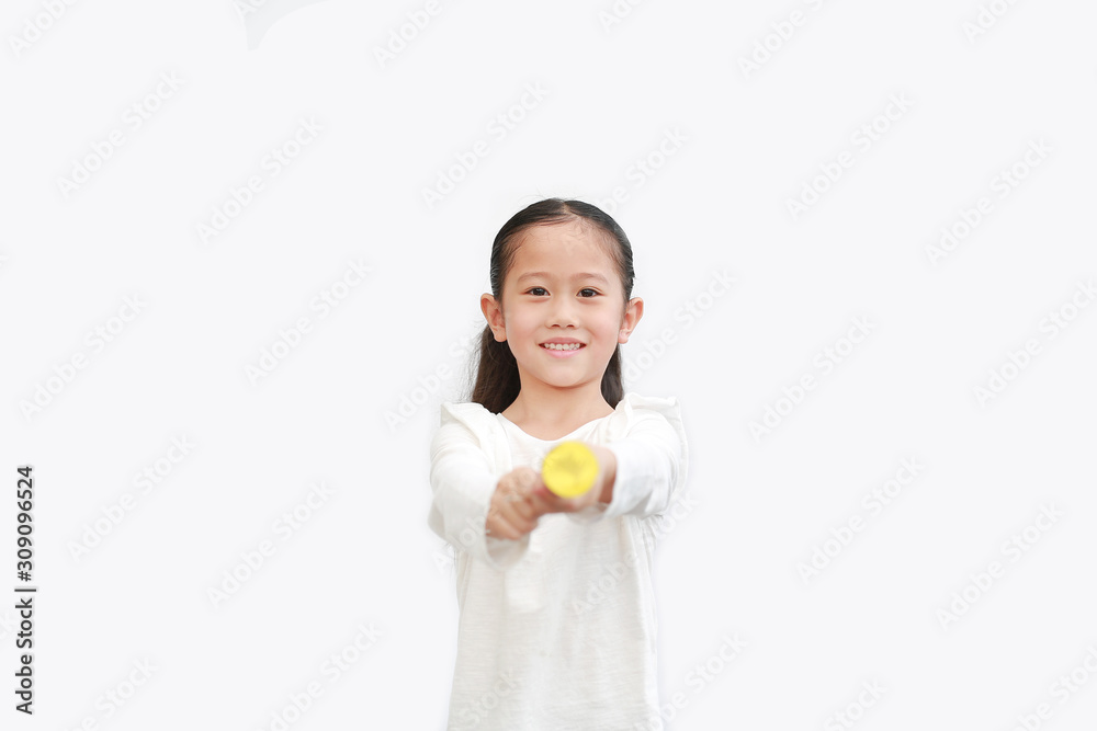 Wall mural Cute little Asian child girl shooting party popper confetti over white background with copy space. Front view.