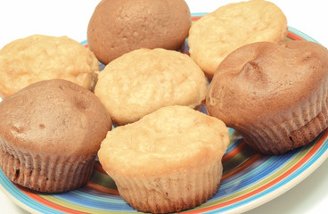 Fresh baked apple and coffee muffins on colorful plate. Delicious dessert