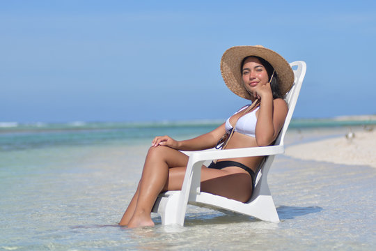 Young lady Woman sitting on chair on the beach  - los roques venezuela