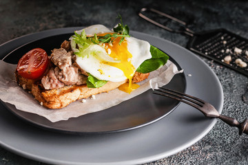 Appetizing seafood and fried egg sandwich. Lettuce, cherry tomatoes and pea sprouts. A healthy and balanced breakfast. Cod Liver Source of Beneficial Omega 3 Fatty Acids