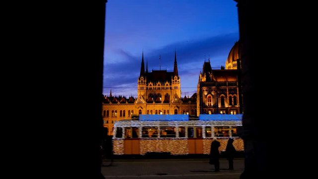 The Christmas tram runs in front of the Parliament in Budapest