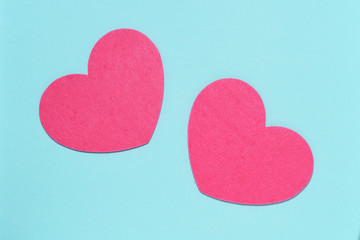 Two pink hearts on a blue background close-up. Greeting card with copy space. Flat lay minimal concept. Valentine's Day background