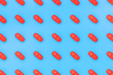 set of red pills on blue background. red pill pattern.