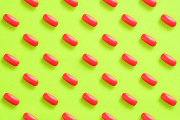 pattern of red pills on a green background. pain pill concept.