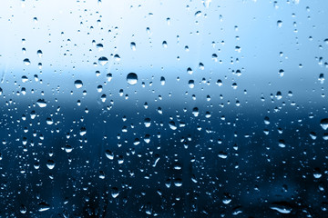 Water droplets texture over blue background. Photo closeup 