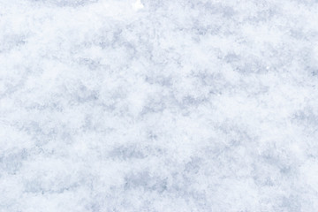 Fototapeta premium Abstract background of fresh white snow closeup. Winter snowflakes texture. Winter snow. Snow texture Top view of the snow. Natural winter background