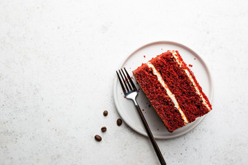 Top view of slice of red velvet cake with copy space on white background.