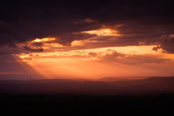 Naklejka premium Country sunset with orange tones in the sky