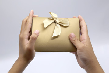 hand hold golden triangular gift box isolated on white background