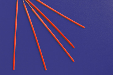 Incense aroma sticks scattered on a dark blue background
