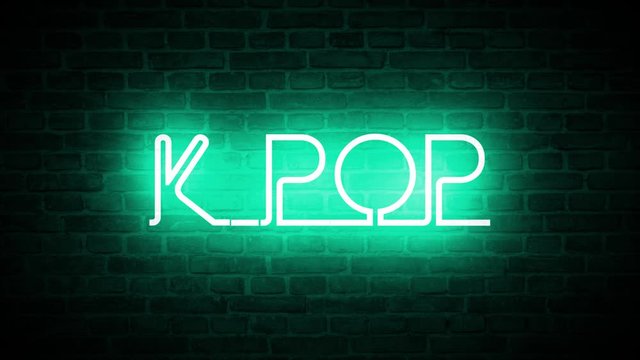 A video of a neon sign against a brick wall that reads: K-POP