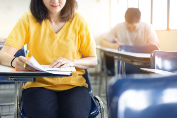 high school,university student study.hands holding pencil writing paper answer sheet.sitting lecture chair taking final exam attending in examination classroom.concept scholarship for education abroad