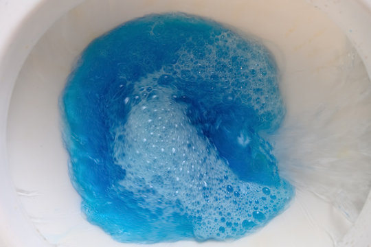 Flushing A Closestool With Blue Water