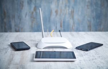 Internet router with smartphones and tablet on the desk. Network, Technology