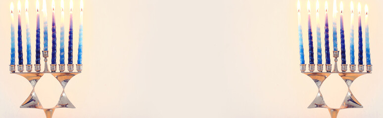 Religion image of jewish holiday Hanukkah background with david star menorah (traditional candelabra) and candles