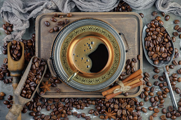 Coffee in a cup and saucer on an old background.
