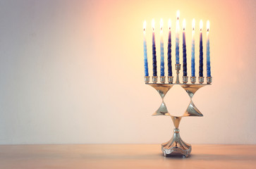 Religion image of jewish holiday Hanukkah background with david star menorah (traditional candelabra) and candles