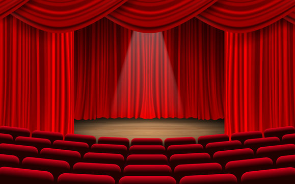 red chairs and red curtain on the stage in the hall