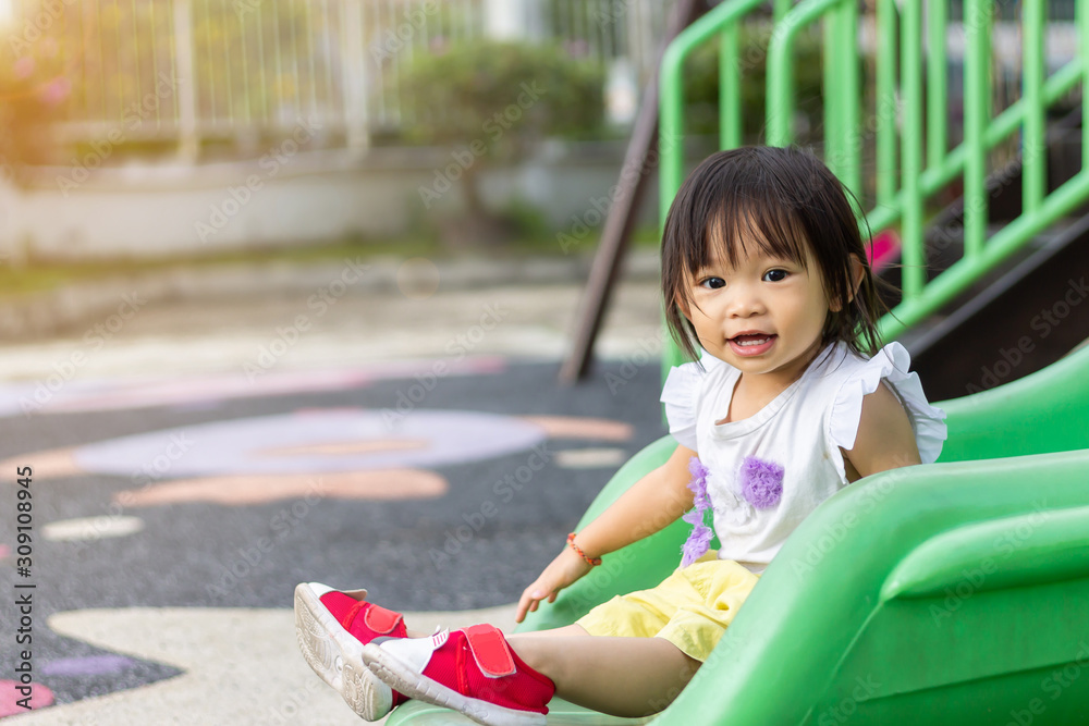 Wall mural Portrait image of 1-2 yeas old baby. Happy Asian child girl smiling and laughing. She playing with slider bar toy at the playground. Learning and active of kids concept.