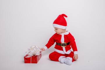 a baby in a Santa Claus costume on a white background