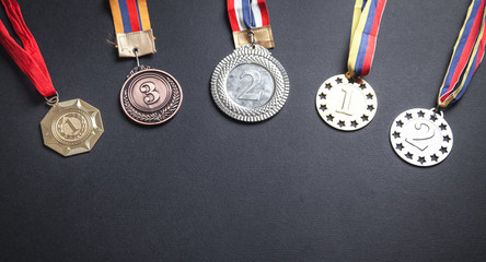 Medal awards for winner on black background.