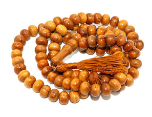 Natural wooden rosary isolated on white background