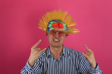 Close-up portrait of a punk man showing fingers