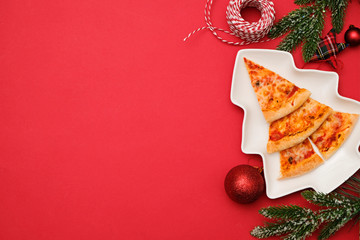 Pizza delivery for christmas concept. Edible christmas tree made from pizza margarita on red...