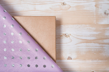 Cardboard box and lilac polka dot wrapping paper. Wooden table. Preparation for the holiday